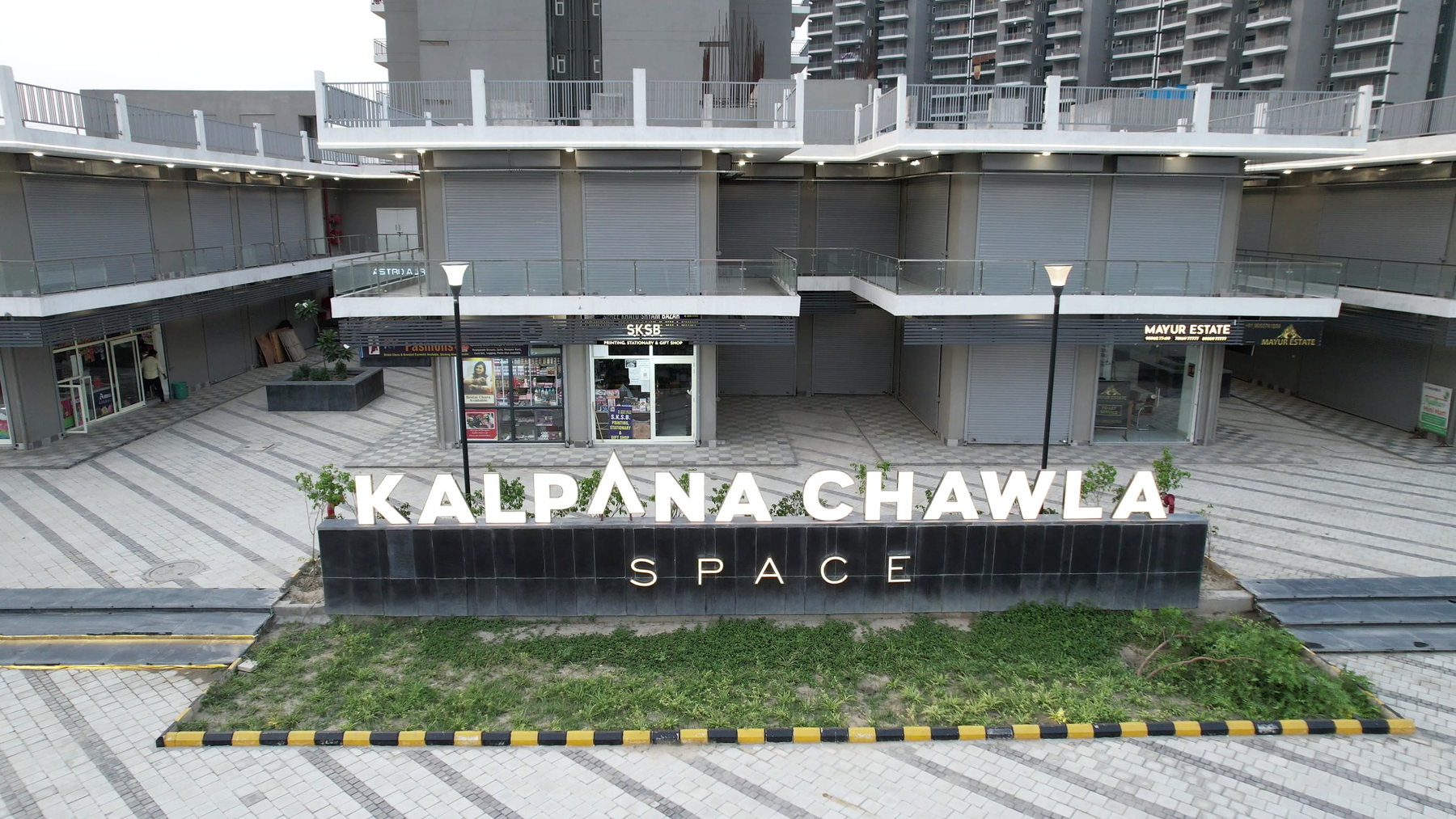 Illuminated project signage and commercial frontage at Kalpana Chawla Space.