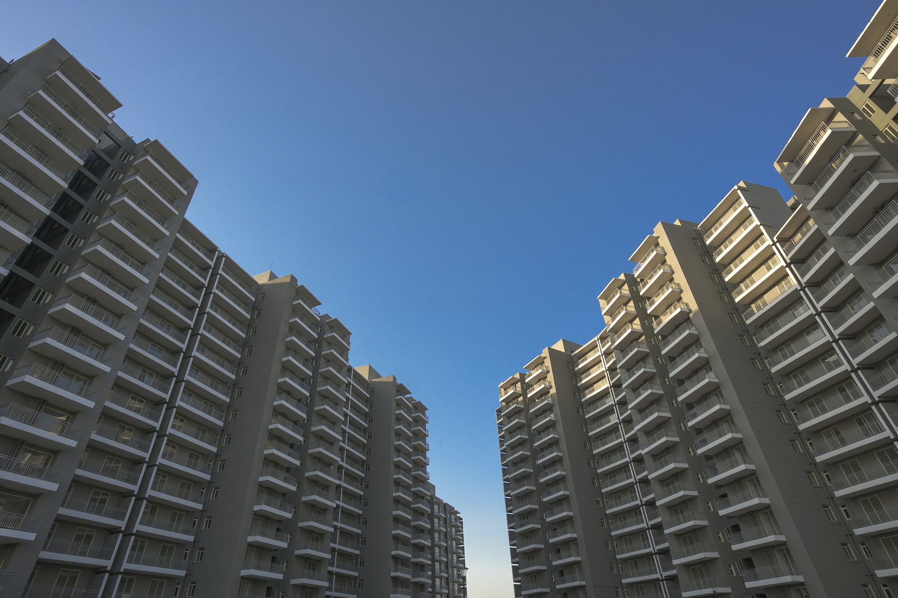 Upward view between residential towers at Smart Homes Karnal.