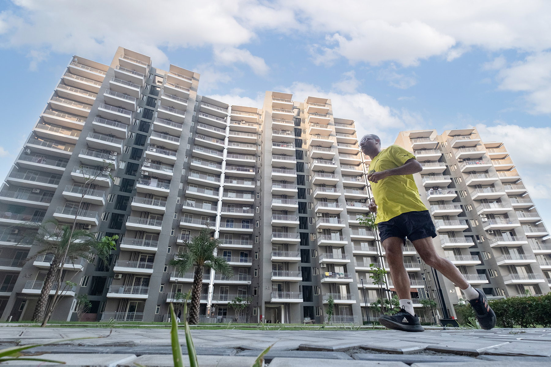 A resident jogging through the completed open space at Smart Homes Karnal.